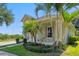 Side exterior with lush landscaping featuring palm trees, offering a glimpse of its charming architectural details at 7201 Halton Ct, Windermere, FL 34786