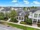 Aerial view of a neighborhood with manicured lawns, palm trees and sidewalks with a cozy porch at 8245 Laureate Blvd, Orlando, FL 32827