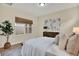 Bright bedroom featuring neutral walls, decorative art, large window, and stylish furnishings at 8245 Laureate Blvd, Orlando, FL 32827