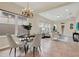 Open-concept dining area with view into living room, offering a modern and airy feel at 8245 Laureate Blvd, Orlando, FL 32827
