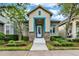 Charming single-story home featuring a well-manicured lawn and inviting blue-accented entryway at 8245 Laureate Blvd, Orlando, FL 32827