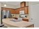 Functional kitchen featuring light countertops and wooden cabinets, next to stainless steel appliances at 8245 Laureate Blvd, Orlando, FL 32827