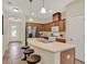 Bright kitchen features stainless steel appliances, a center island with breakfast bar, and warm wood cabinetry at 8245 Laureate Blvd, Orlando, FL 32827