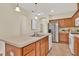 Spacious kitchen features stainless steel appliances, breakfast bar, and warm wood cabinets, ideal for entertaining at 8245 Laureate Blvd, Orlando, FL 32827