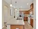 Spacious kitchen features stainless steel appliances, breakfast bar, and warm wood cabinets, ideal for entertaining at 8245 Laureate Blvd, Orlando, FL 32827