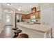 Bright kitchen features stainless steel appliances, a center island with breakfast bar, and warm wood cabinetry at 8245 Laureate Blvd, Orlando, FL 32827
