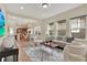 Open-concept living room with modern decor seamlessly connecting to dining and kitchen areas at 8245 Laureate Blvd, Orlando, FL 32827