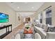 Spacious living room with modern furniture and a clear view into the kitchen and dining areas at 8245 Laureate Blvd, Orlando, FL 32827