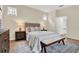 Comfortable main bedroom with neutral tones, a plush bed, and an ensuite bathroom entrance at 8245 Laureate Blvd, Orlando, FL 32827