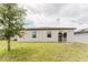 Backyard featuring a green lawn and white siding at 856 Teton St, Haines City, FL 33844