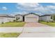 Cozy single-Gathering home showcasing a brick driveway and landscaped front yard at 856 Teton St, Haines City, FL 33844