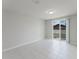 Open living room with tile flooring and sliding glass door at 856 Teton St, Haines City, FL 33844