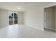 Living room with tile floors, a sliding glass door, and neutral walls at 856 Teton St, Haines City, FL 33844