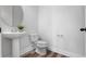 Bathroom with pedestal sink, modern faucet, and contemporary toilet at 8692 Tavistock Lakes Blvd, Orlando, FL 32827