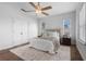 Bedroom features large windows, decoratice rug, and closet, making it bright and functional at 8692 Tavistock Lakes Blvd, Orlando, FL 32827