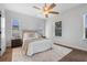 Inviting bedroom with large windows, decorative rug, and neutral decor provides a relaxing retreat at 8692 Tavistock Lakes Blvd, Orlando, FL 32827