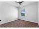 Bedroom with carpet, window, and a ceiling fan at 8692 Tavistock Lakes Blvd, Orlando, FL 32827