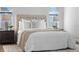 This cozy bedroom is complete with decorative rug, neutral decor, and bedside tables at 8692 Tavistock Lakes Blvd, Orlando, FL 32827