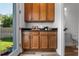 Butler's Pantry with lots of cabinet space, granite countertops, and view of the backyard at 8692 Tavistock Lakes Blvd, Orlando, FL 32827