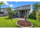 Exterior backyard view of the home, showing patio and shade trees at 8692 Tavistock Lakes Blvd, Orlando, FL 32827