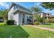 Charming two-story home with manicured lawn, brick pathway, and blue accent front door at 8692 Tavistock Lakes Blvd, Orlando, FL 32827