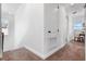 Hallway with carpeted floor, white walls, built-in cabinet and table with chair at 8692 Tavistock Lakes Blvd, Orlando, FL 32827