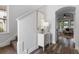 Bright hallway featuring stylish wood floors, a modern console table, and staircase at 8692 Tavistock Lakes Blvd, Orlando, FL 32827