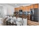 Modern kitchen with a granite countertop island, stainless steel appliances, and comfortable seating at 8692 Tavistock Lakes Blvd, Orlando, FL 32827