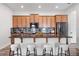 Charming kitchen with stylish wooden cabinetry, granite countertops, and a breakfast bar with seating for casual dining at 8692 Tavistock Lakes Blvd, Orlando, FL 32827