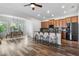 Modern kitchen with island seating and stainless steel appliances, adjacent to dining area at 8692 Tavistock Lakes Blvd, Orlando, FL 32827