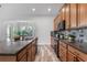 Spacious kitchen with granite countertops, stainless steel appliances, and a view to the dining area at 8692 Tavistock Lakes Blvd, Orlando, FL 32827