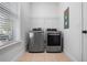 Laundry room with newer front load washer and dryer and a window at 8692 Tavistock Lakes Blvd, Orlando, FL 32827