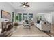 Bright living room with stylish floors, large windows, comfortable sofas, and modern décor at 8692 Tavistock Lakes Blvd, Orlando, FL 32827