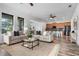 Bright, open living room with neutral tones and plenty of natural light flowing into an open kitchen area at 8692 Tavistock Lakes Blvd, Orlando, FL 32827