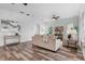 Spacious living room with wood floors, neutral walls, modern decor, and plenty of natural light at 8692 Tavistock Lakes Blvd, Orlando, FL 32827