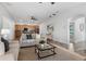 Open-concept living space with a spacious layout, stylish furnishings, and seamless flow into the kitchen at 8692 Tavistock Lakes Blvd, Orlando, FL 32827