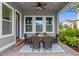 Inviting covered patio featuring a ceiling fan, brick flooring, and comfortable seating arrangement at 8692 Tavistock Lakes Blvd, Orlando, FL 32827