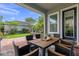 Cozy covered patio with brick flooring, stylish outdoor furniture, and lush backyard views at 8692 Tavistock Lakes Blvd, Orlando, FL 32827
