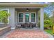 Charming covered patio with brick flooring, ceiling fan, and an inviting outdoor dining space at 8692 Tavistock Lakes Blvd, Orlando, FL 32827