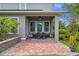 Cozy covered patio featuring brick flooring, ample natural light, and a comfortable dining area at 8692 Tavistock Lakes Blvd, Orlando, FL 32827