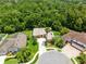 Aerial view showcasing a well-maintained home with lush landscaping and a circular driveway at 9330 Shadow Pinar Ct, Orlando, FL 32825