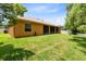 Expansive backyard featuring a well-maintained lawn, screened-in porch, and secure white fencing at 9330 Shadow Pinar Ct, Orlando, FL 32825