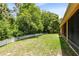 Lush backyard with a white fence bordering a well-manicured lawn and beautiful foliage at 9330 Shadow Pinar Ct, Orlando, FL 32825