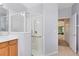 This bathroom features a walk-in shower with glass enclosure, neutral paint, and tiled floors at 9330 Shadow Pinar Ct, Orlando, FL 32825