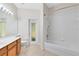 This bathroom features a single sink vanity, a toilet, and a shower-tub combo with tiled floors at 9330 Shadow Pinar Ct, Orlando, FL 32825