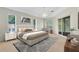 This bedroom features a ceiling fan, neutral paint, carpet flooring, and sliding glass doors to the lanai at 9330 Shadow Pinar Ct, Orlando, FL 32825