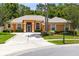 Charming single-story home with a well-manicured lawn, mature landscaping, and a wide concrete driveway at 9330 Shadow Pinar Ct, Orlando, FL 32825