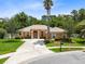 Inviting single-story home boasts a well-manicured lawn and mature landscaping, highlighting its curb appeal at 9330 Shadow Pinar Ct, Orlando, FL 32825
