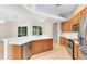 Modern kitchen with quartz countertops, stainless steel appliances, and a sleek breakfast bar at 9330 Shadow Pinar Ct, Orlando, FL 32825