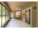 Relaxing screened lanai with ceiling fan and access to the home's interior, perfect for outdoor enjoyment at 9330 Shadow Pinar Ct, Orlando, FL 32825
